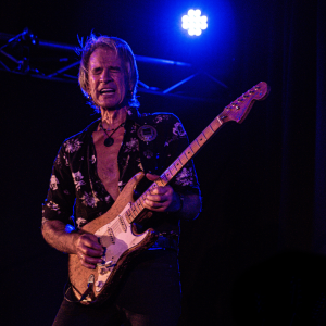 Kevin borich playing a guitar on stage